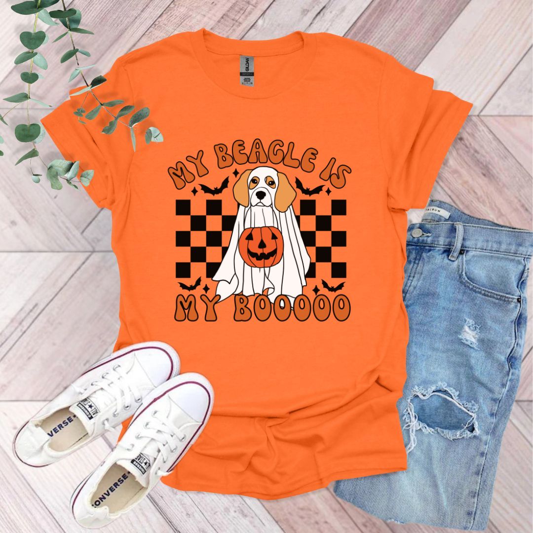 an orange shirt with a dog wearing a pumpkin on it