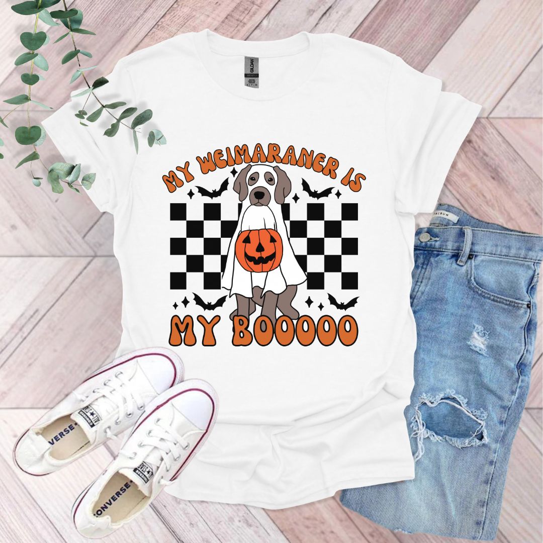 a white shirt with a dog wearing a pumpkin on it