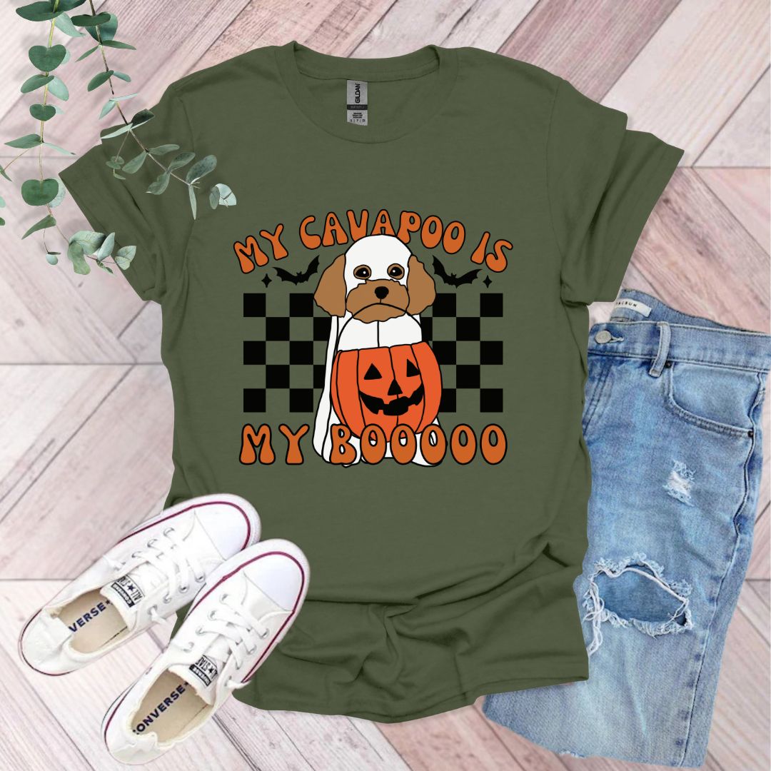 a green shirt with a dog wearing a pumpkin on it