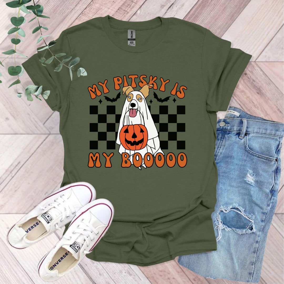 a green shirt with a dog wearing a pumpkin on it