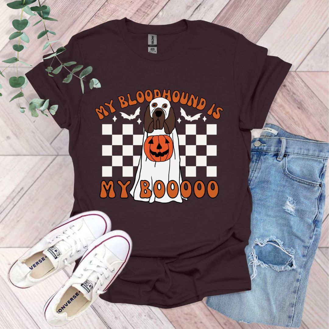 a shirt with a dog wearing a pumpkin on it