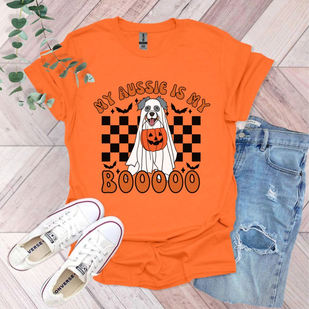 an orange shirt with a dog wearing a pumpkin on it