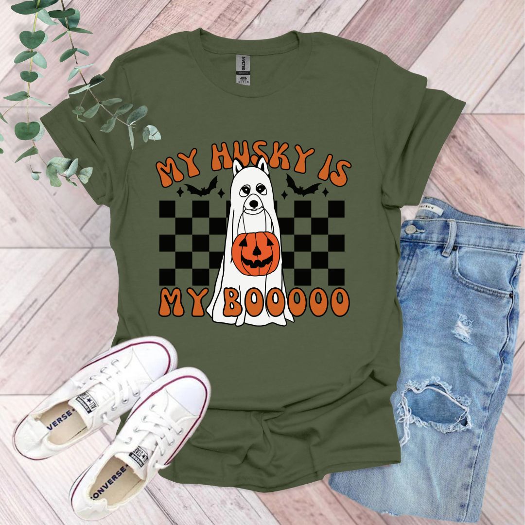 a green shirt with a ghost and pumpkin on it