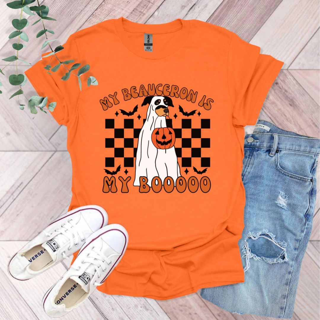 an orange shirt with a dog wearing a pumpkin on it