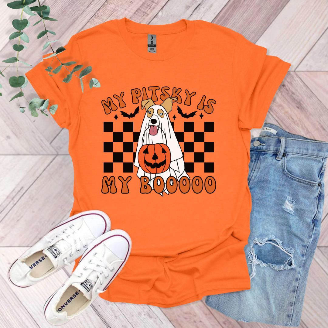 an orange shirt with an image of a dog wearing a pumpkin on it