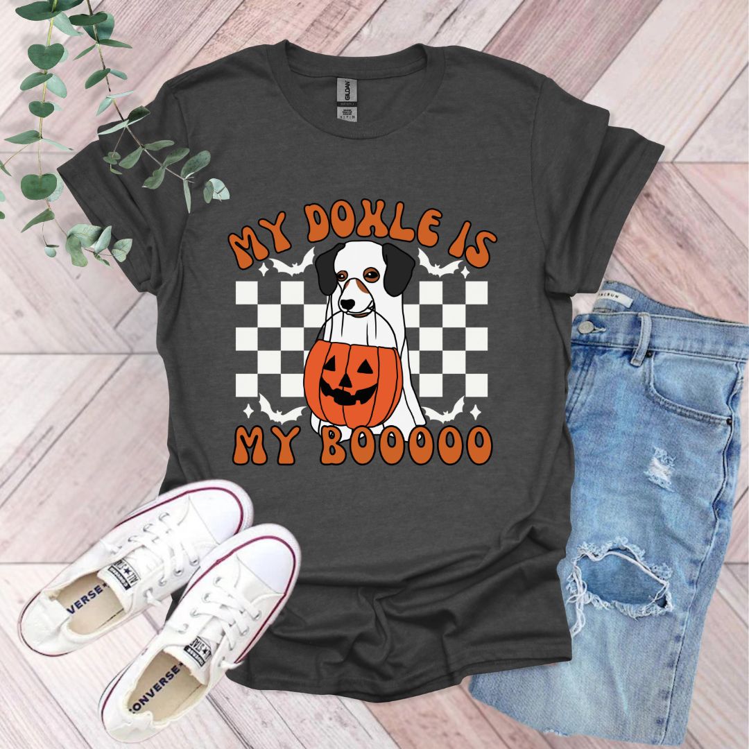 a black shirt with a picture of a dog holding a jack - o - lantern