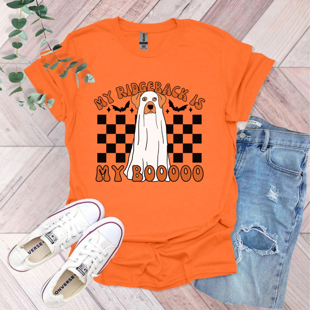 an orange shirt with a white dog on it