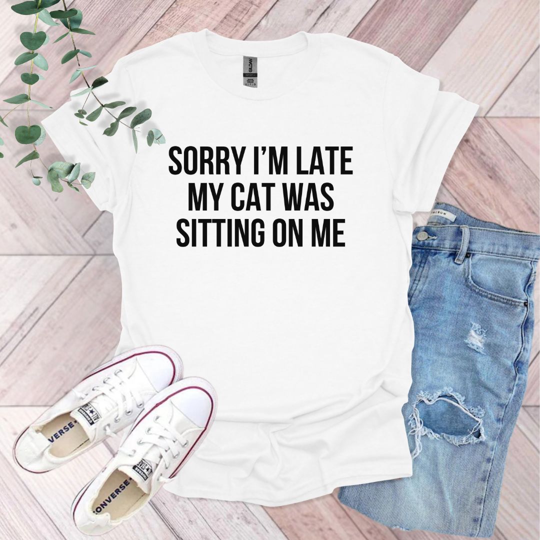 a white shirt that says sorry i'm late my cat was sitting on me