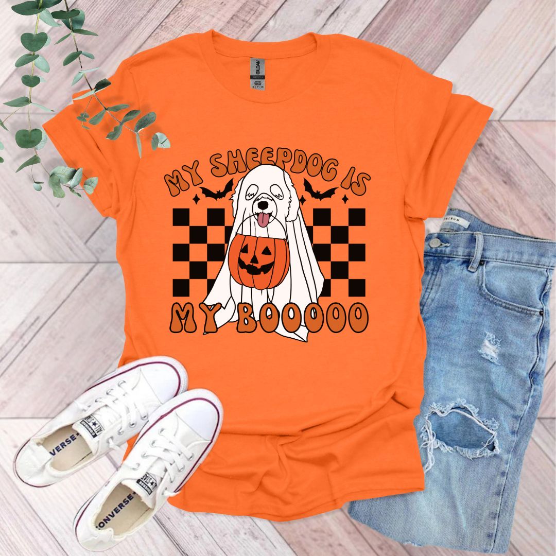 an orange shirt with a dog wearing a pumpkin on it