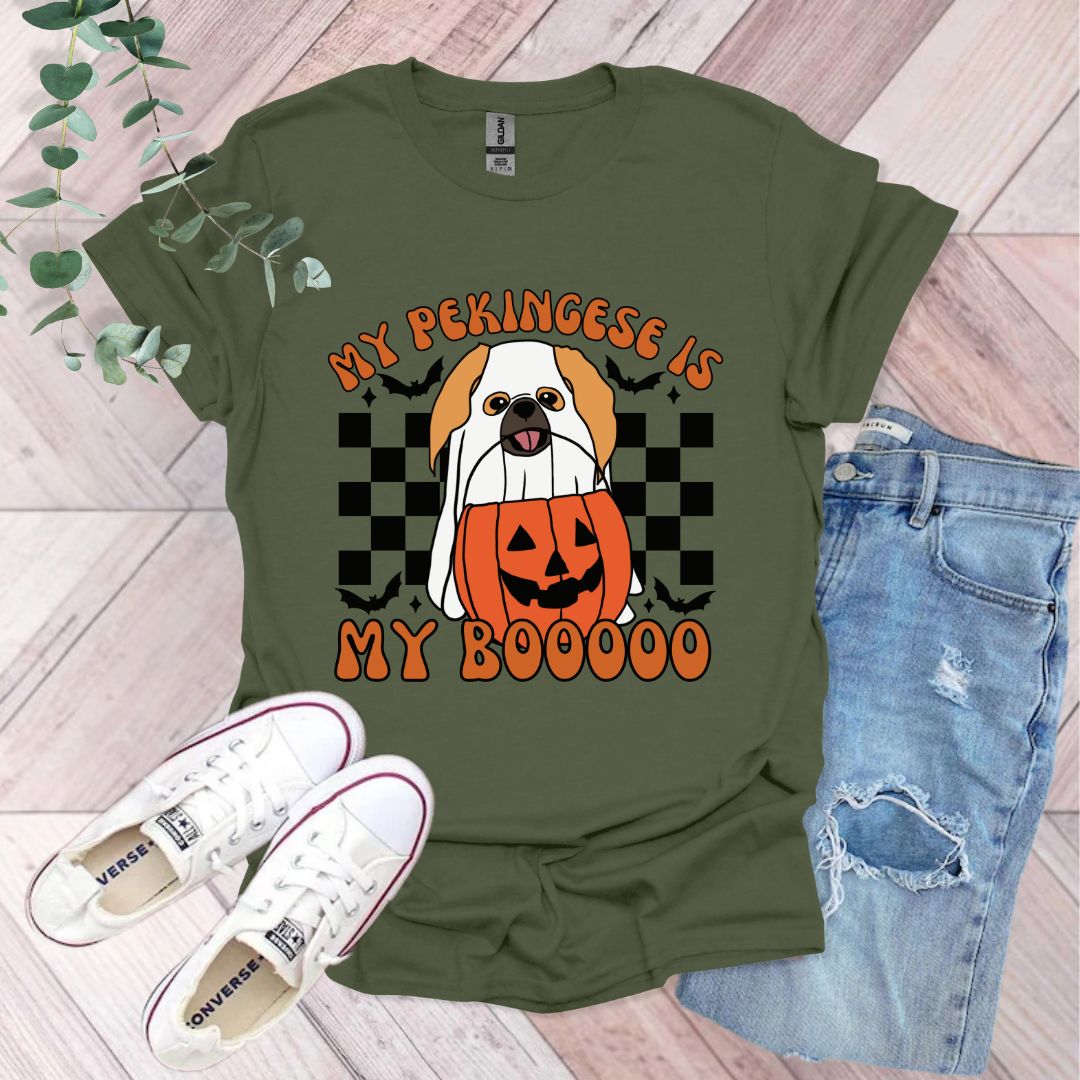 a green shirt with a dog wearing a pumpkin costume