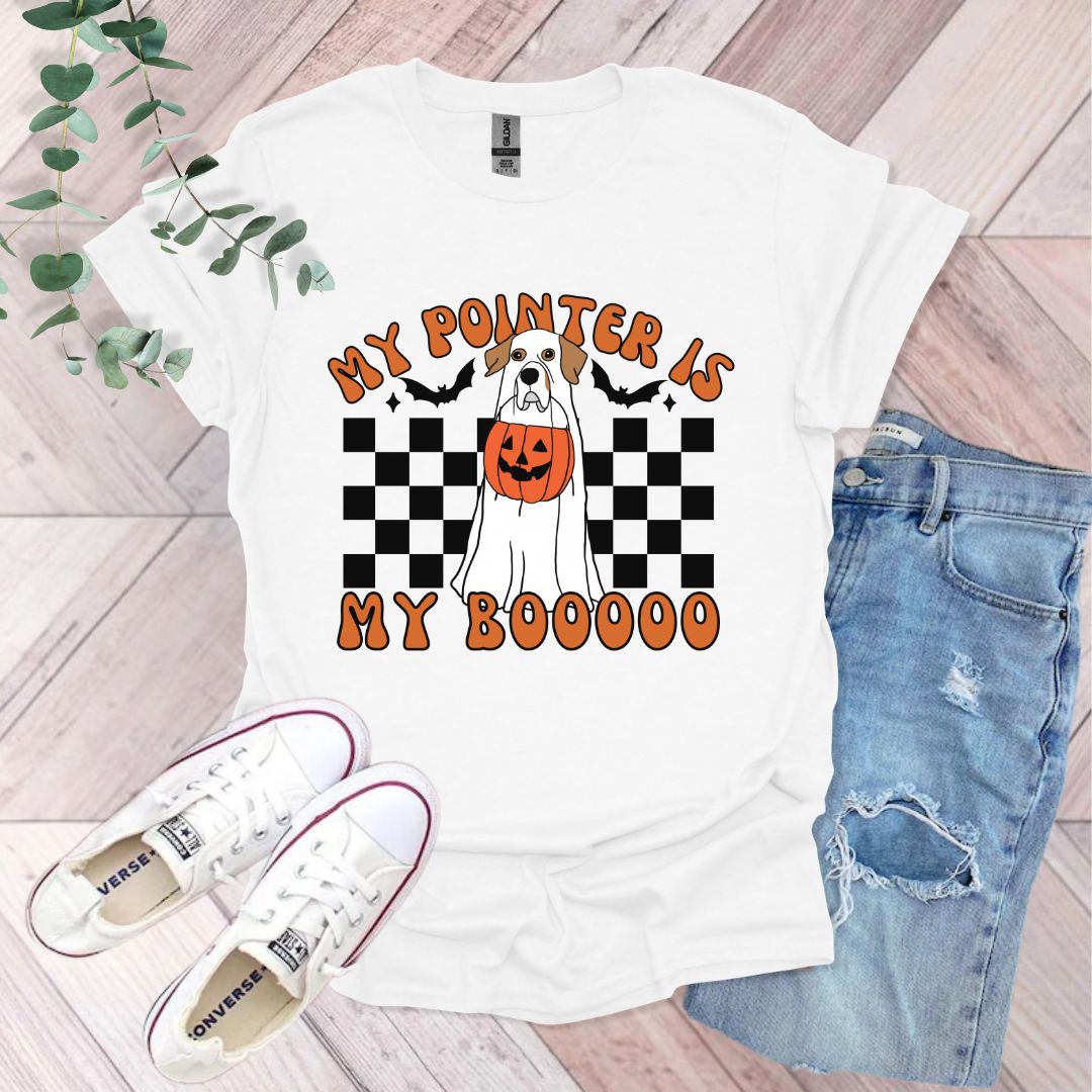 a t - shirt with a dog holding a pumpkin on it