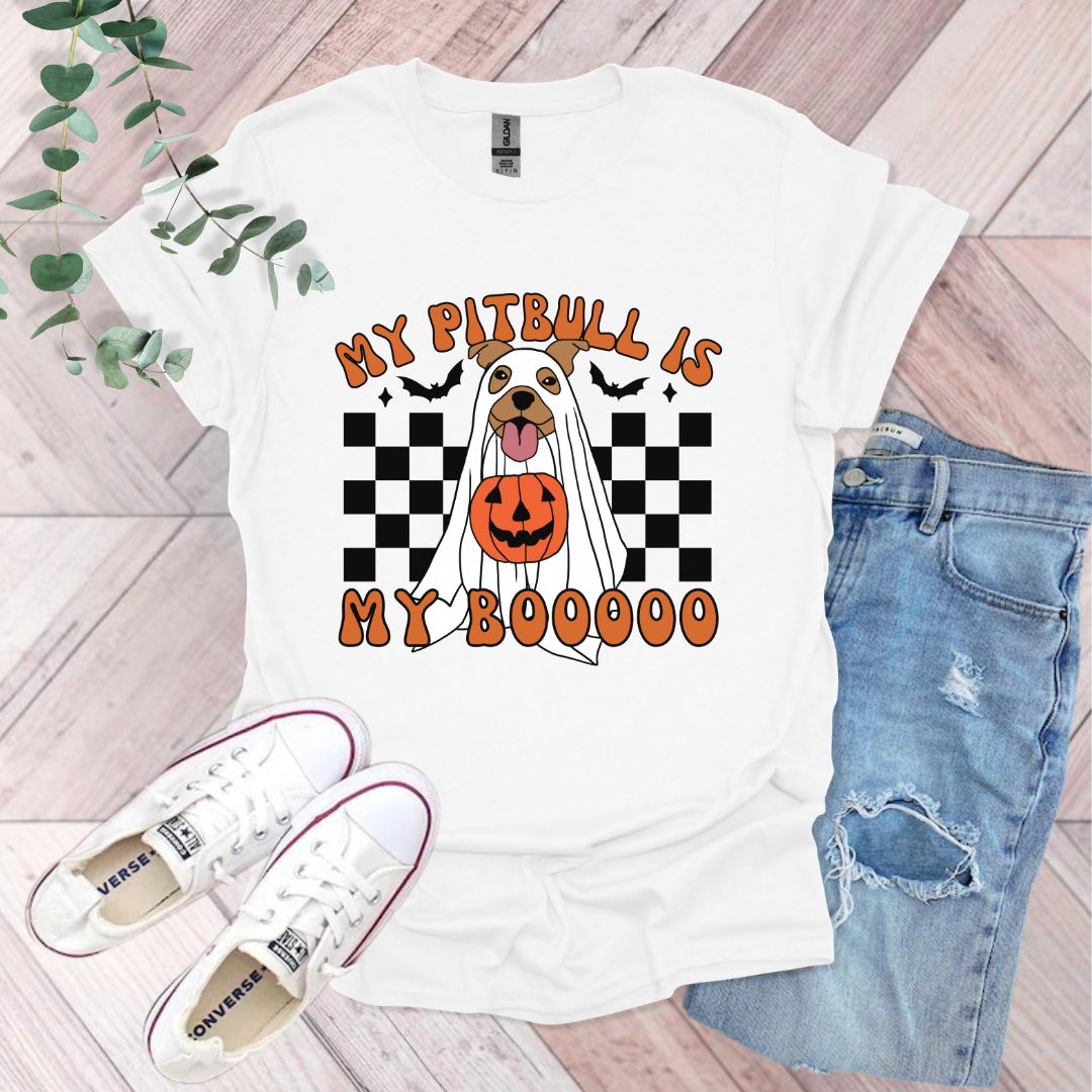 a white shirt with a dog wearing a pumpkin on it