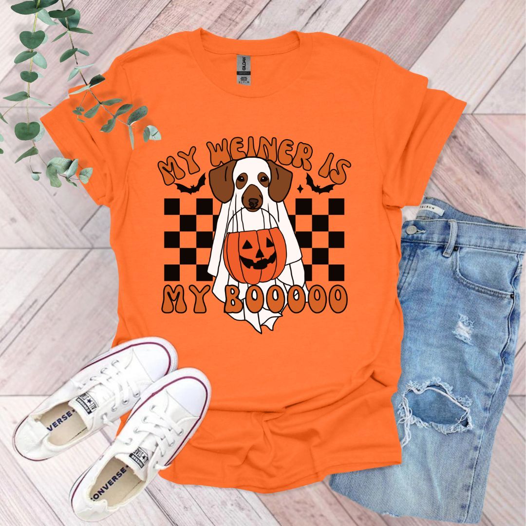 an orange shirt with a dog wearing a pumpkin on it