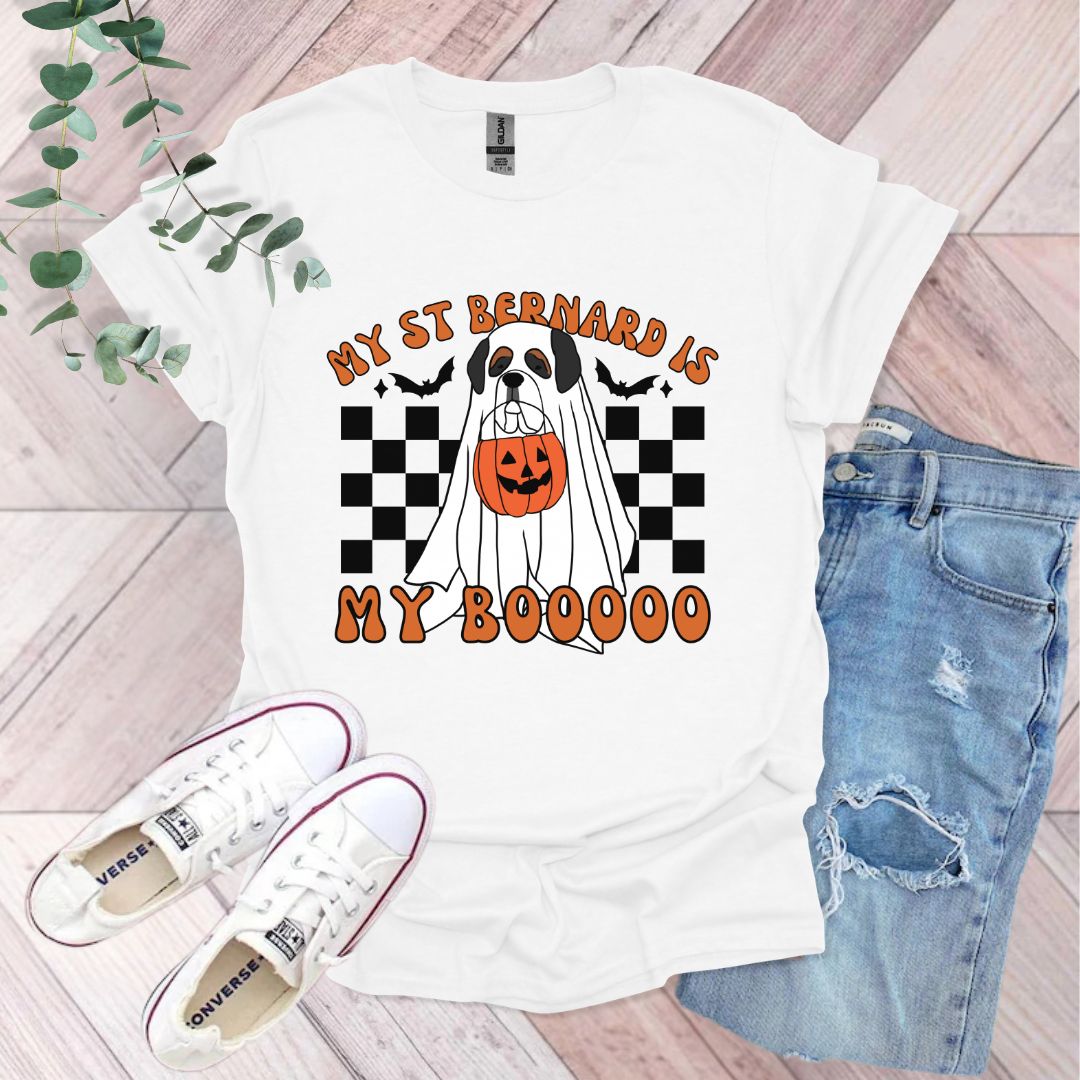 a white t - shirt with a black and white dog wearing a pumpkin on it