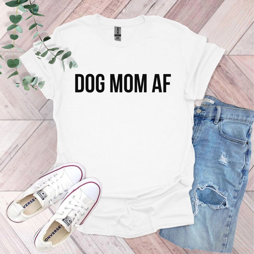 a t - shirt that says dog mom af next to a pair of ripped jeans