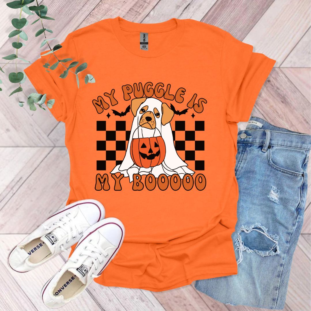 an orange shirt with a dog wearing a pumpkin on it