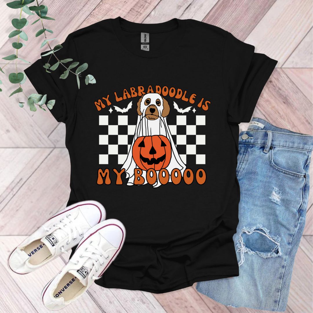a black shirt with a dog wearing a pumpkin on it