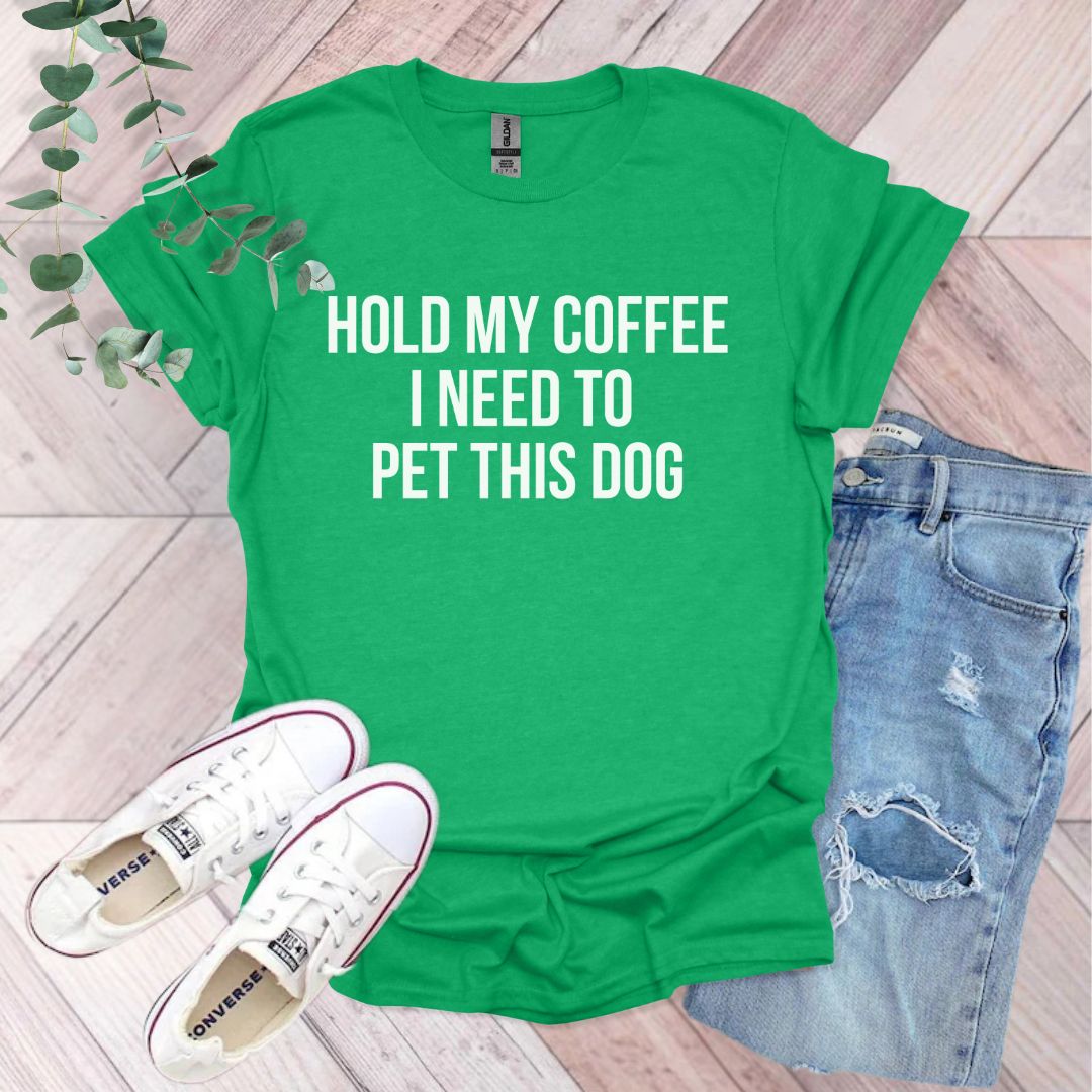 a green shirt that says hold my coffee i need to pet this dog