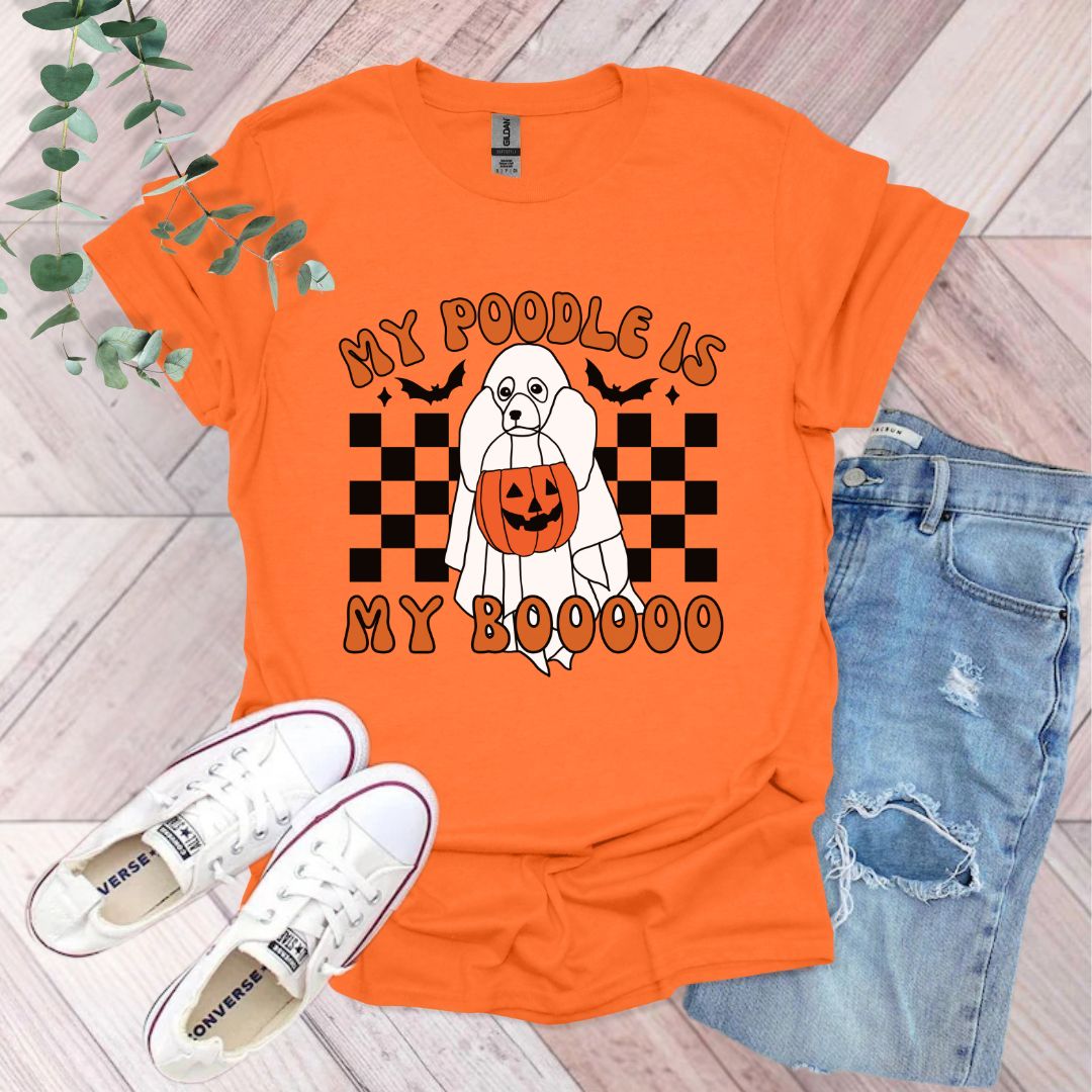 an orange tshirt with a white poodle holding a jack - o -