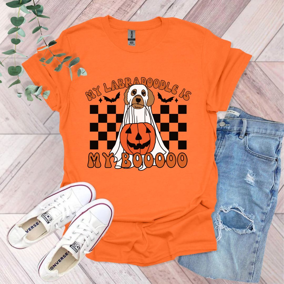 an orange shirt with a dog wearing a pumpkin on it
