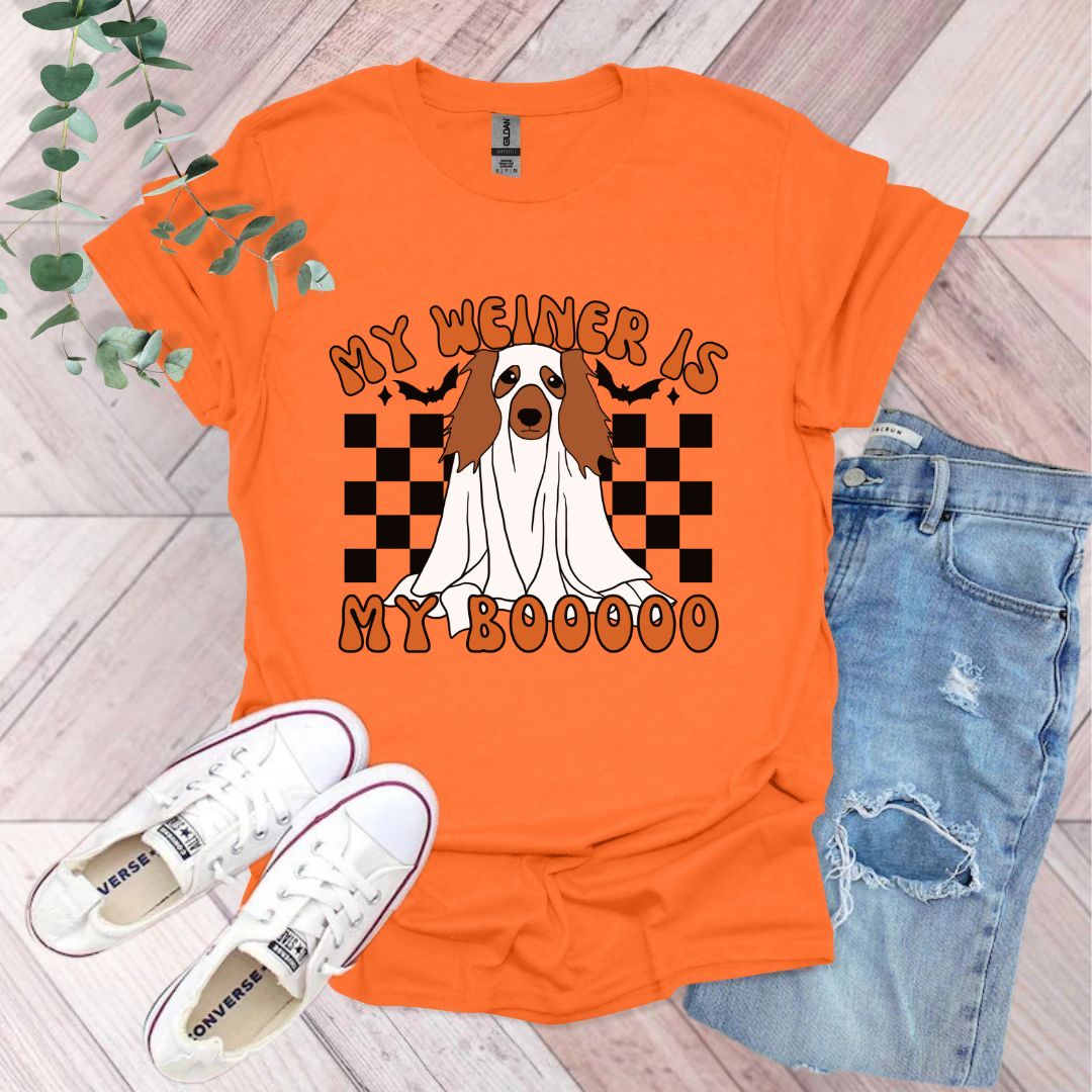 an orange shirt with a brown and white dog on it
