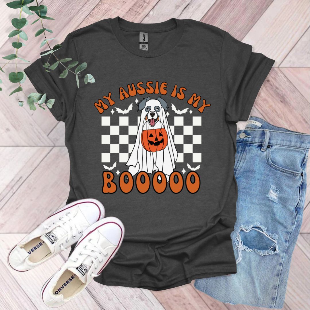 a black shirt with a white dog wearing a pumpkin on it