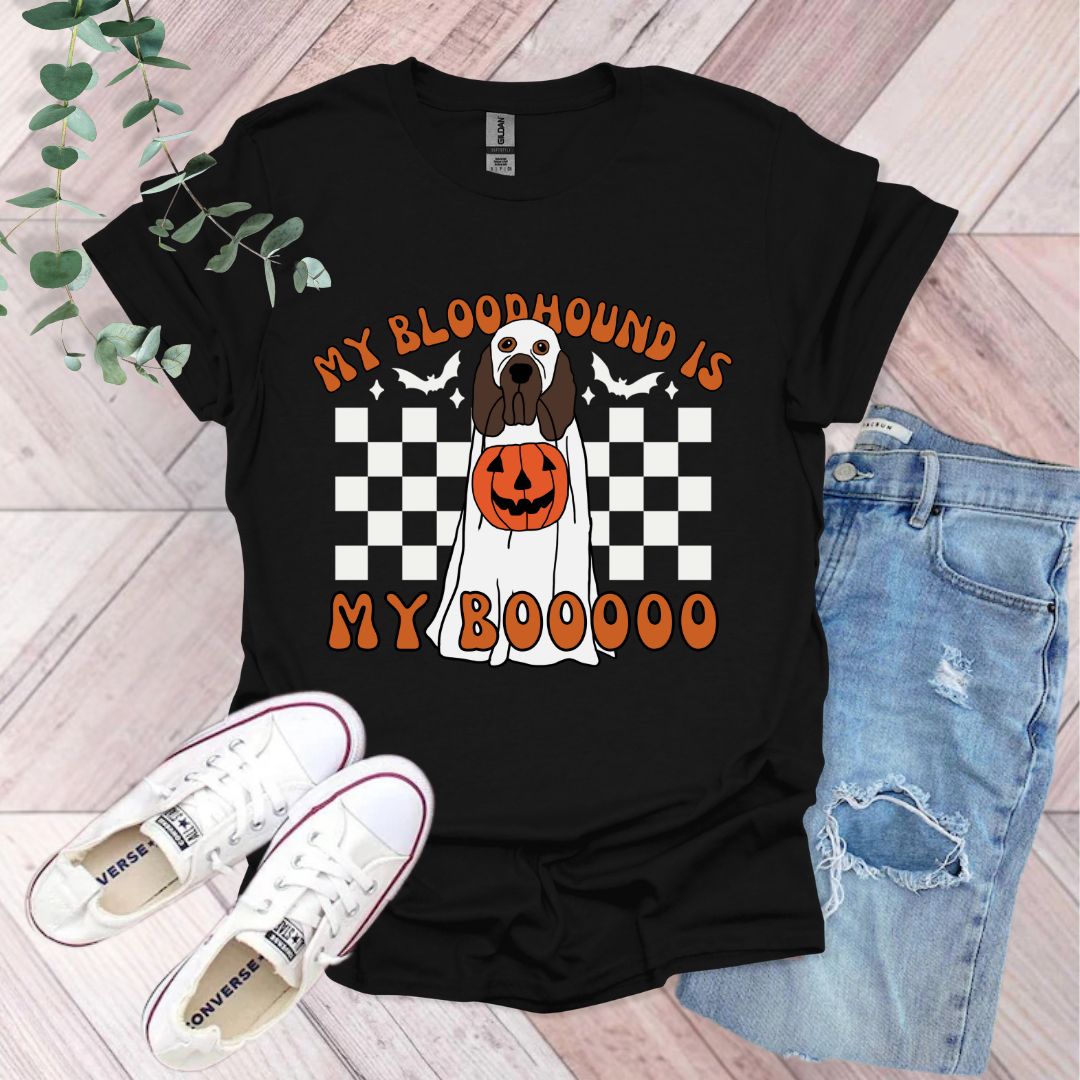 a black shirt with a dog wearing a pumpkin on it