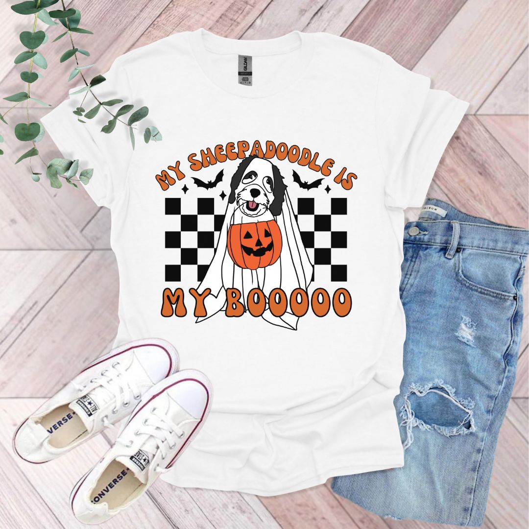 a white t - shirt with a black and white dog in a pumpkin costume