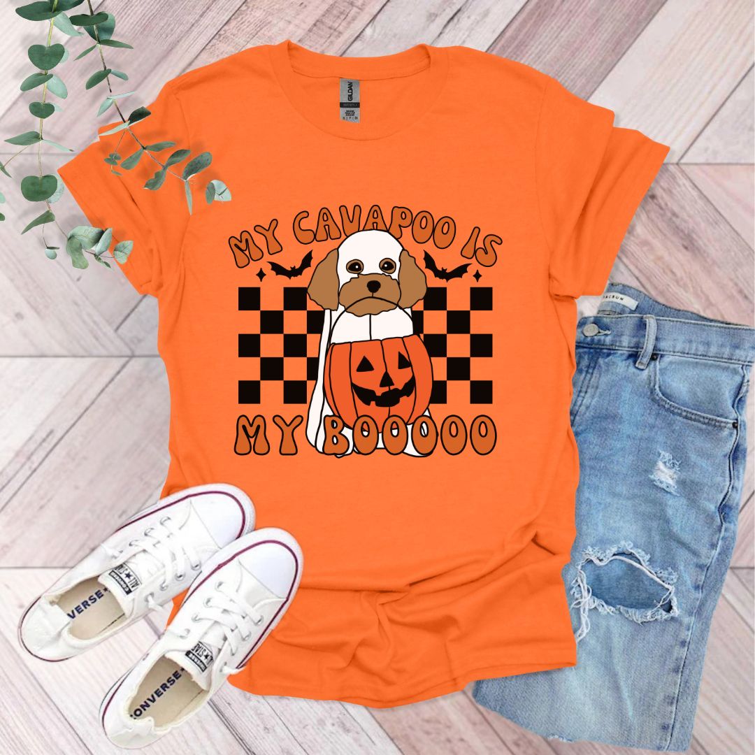 an orange shirt with a dog wearing a pumpkin on it