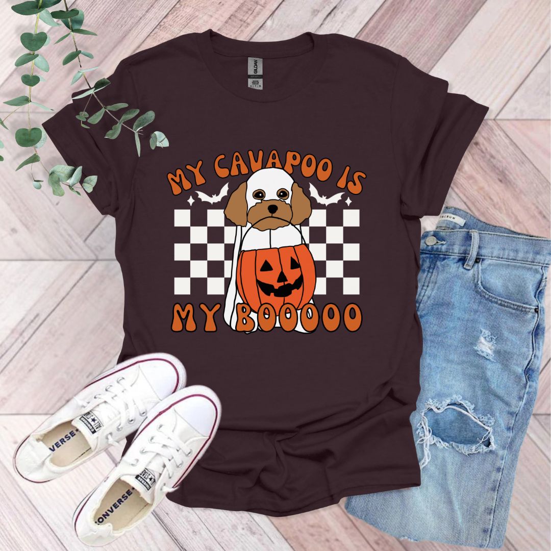 a dog wearing a pumpkin costume with a checkered background