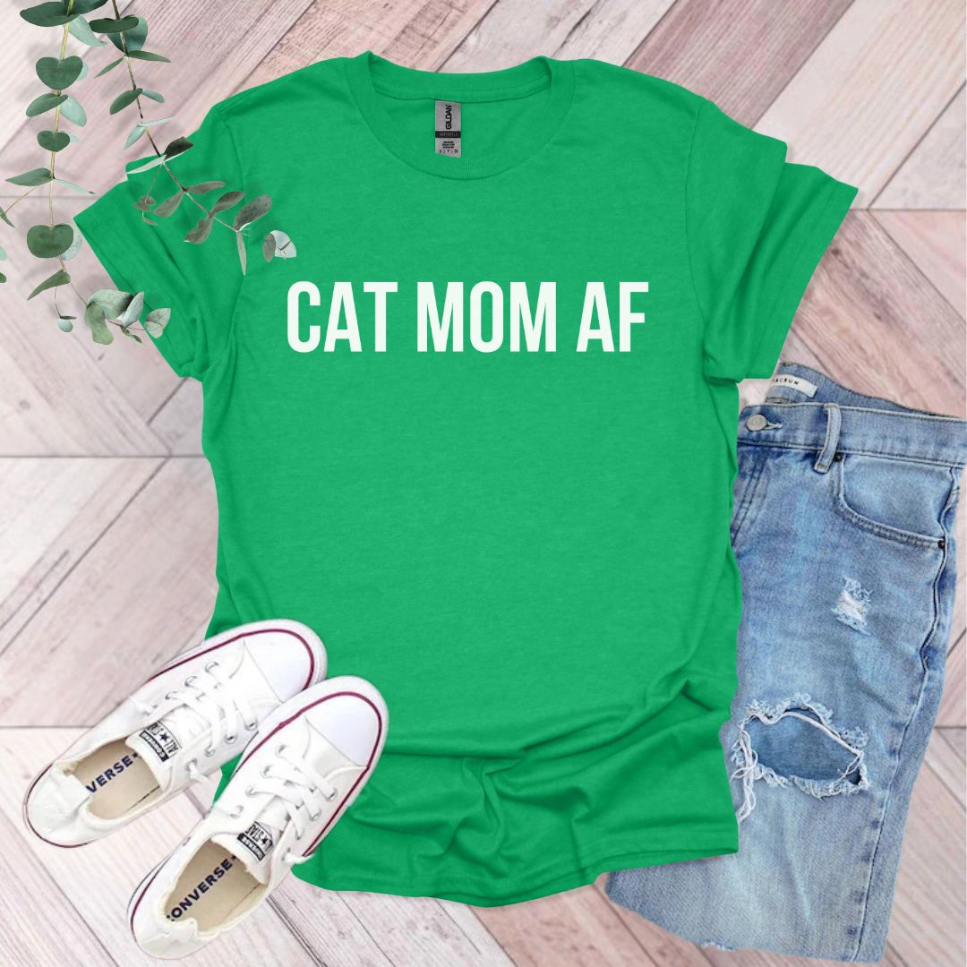 a green shirt that says cat mom af next to a pair of jeans