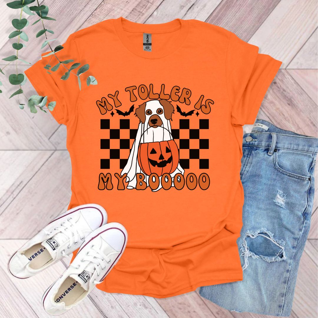 an orange shirt with a dog wearing a pumpkin on it