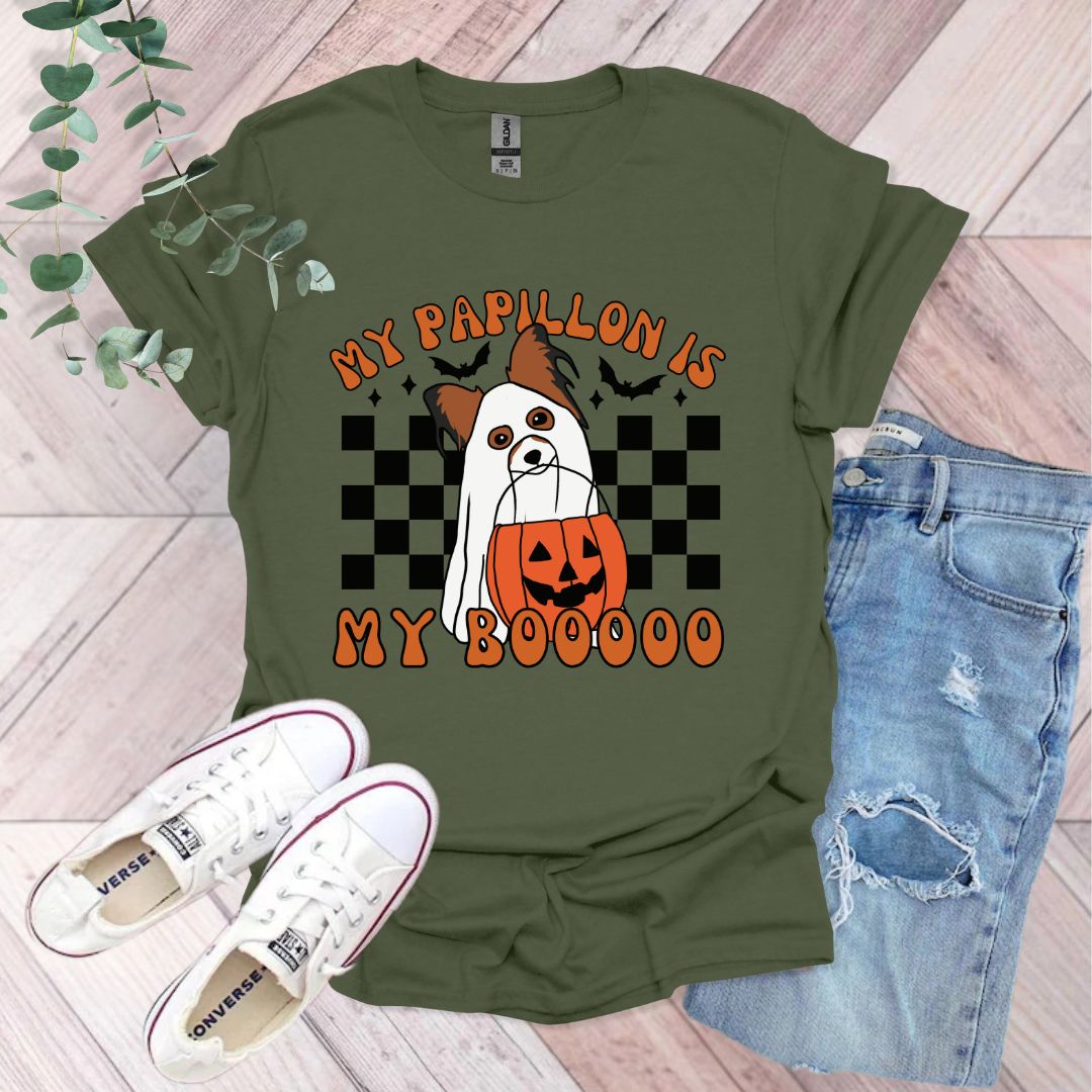 a green shirt with a dog wearing a pumpkin on it