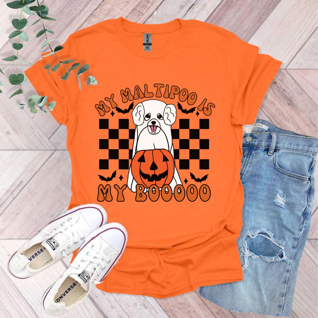 an orange shirt with a dog wearing a pumpkin on it