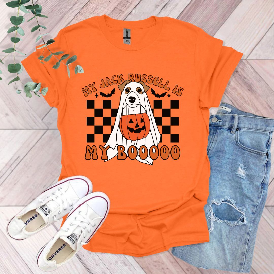 an orange shirt with a white dog wearing a jack - o'- lantern pumpkin