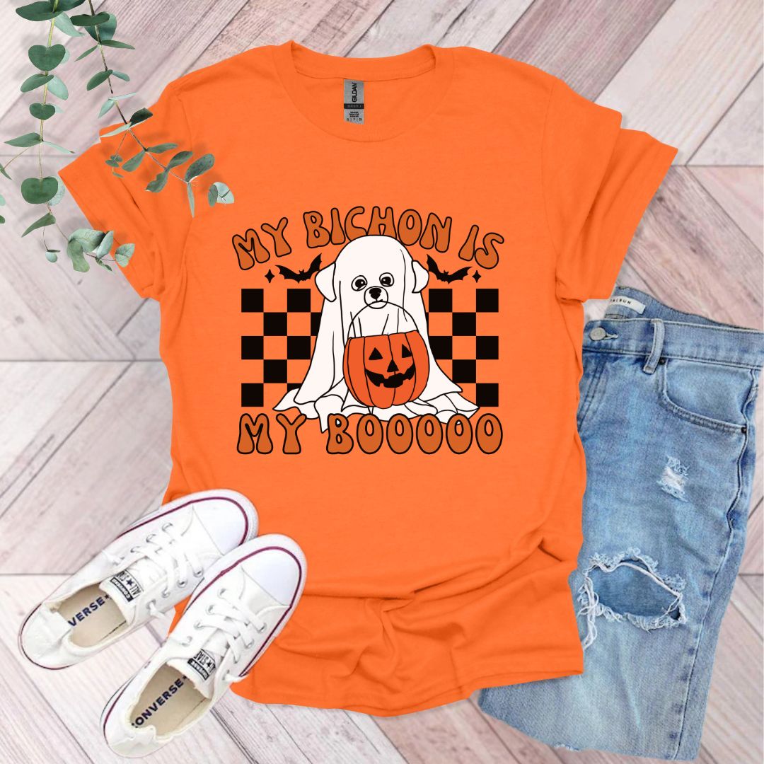 an orange shirt with a dog wearing a jack o lantern pumpkin