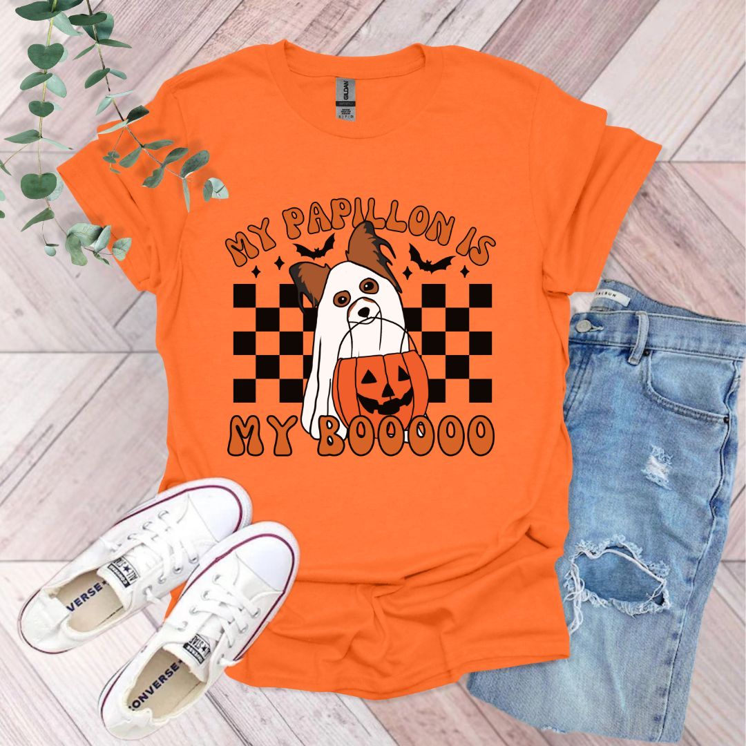 an orange shirt with a white dog on it