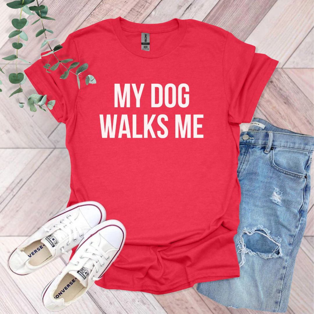 a red shirt that says, my dog walks me
