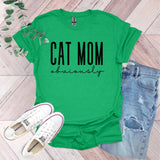 a green shirt that says cat mom university next to a pair of jeans