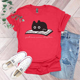 a red shirt with a black cat reading a book