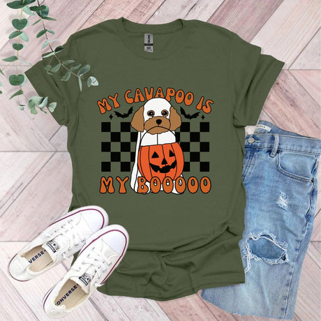 a green shirt with a dog wearing a pumpkin on it
