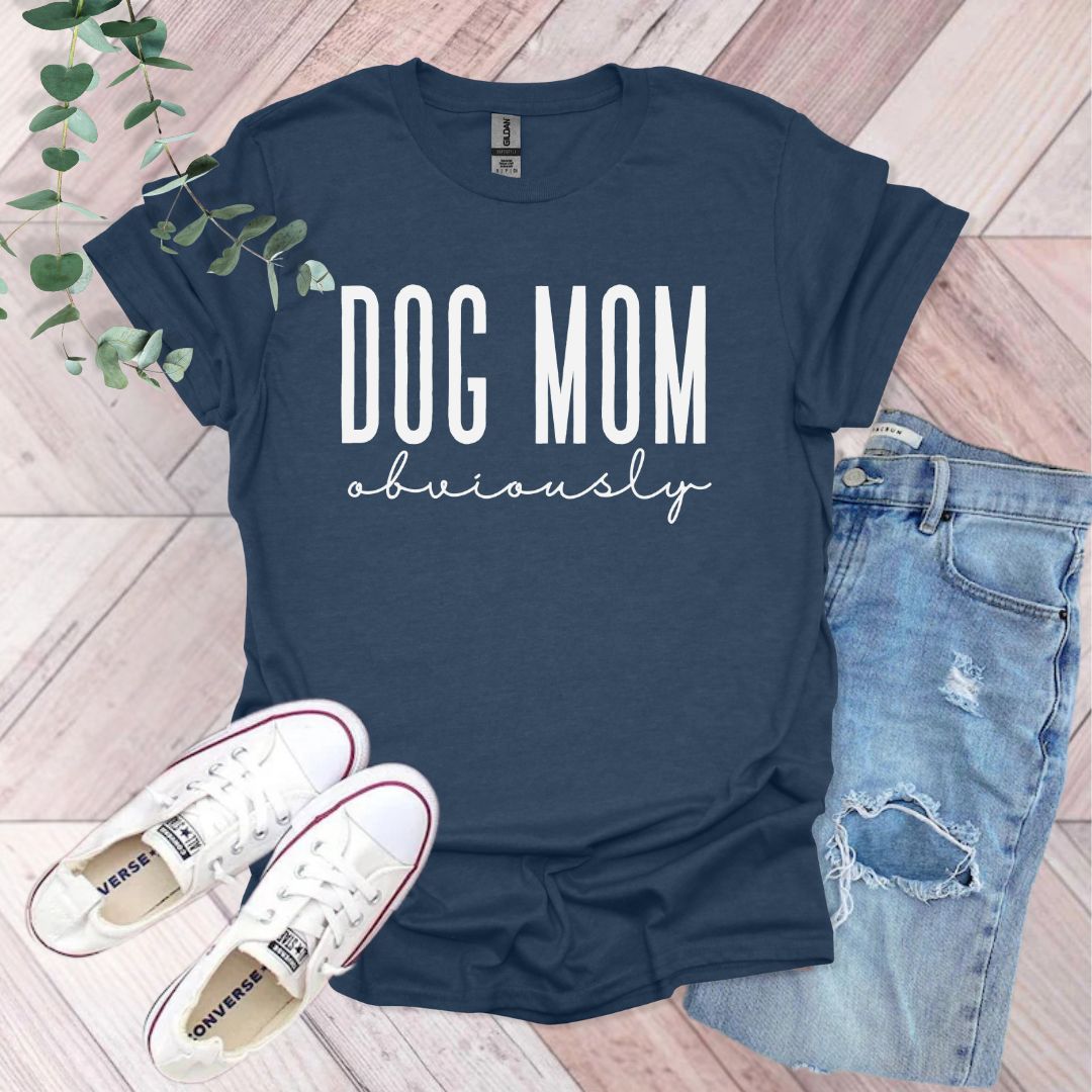 a t - shirt that says dog mom university next to a pair of jeans