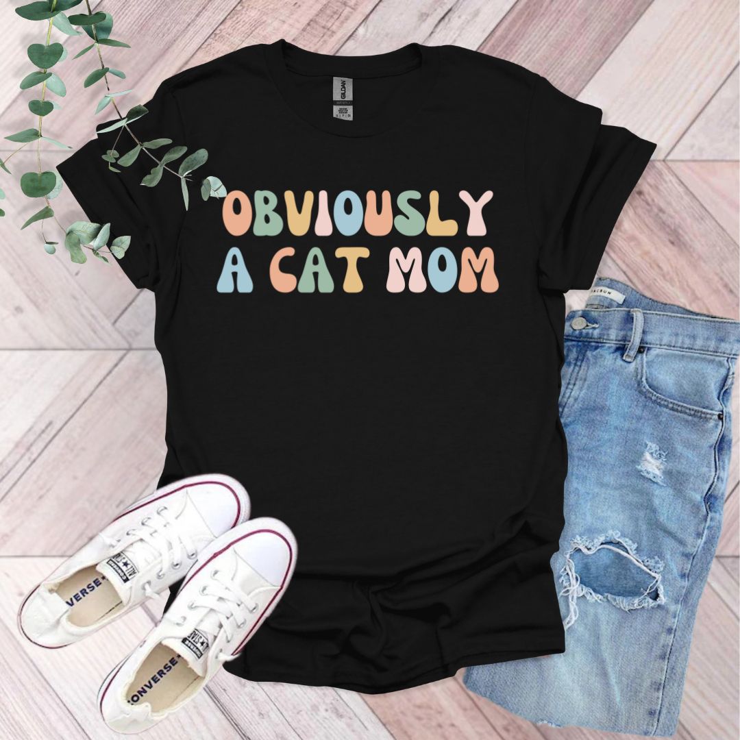 a black t - shirt with the words obviously a cat mom printed on it