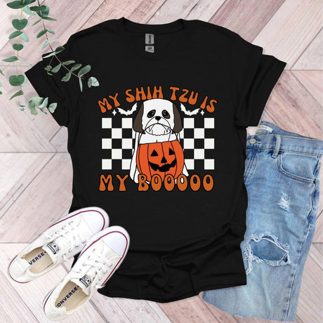 a black shirt with a pumpkin and a jack - o'- lantern on it