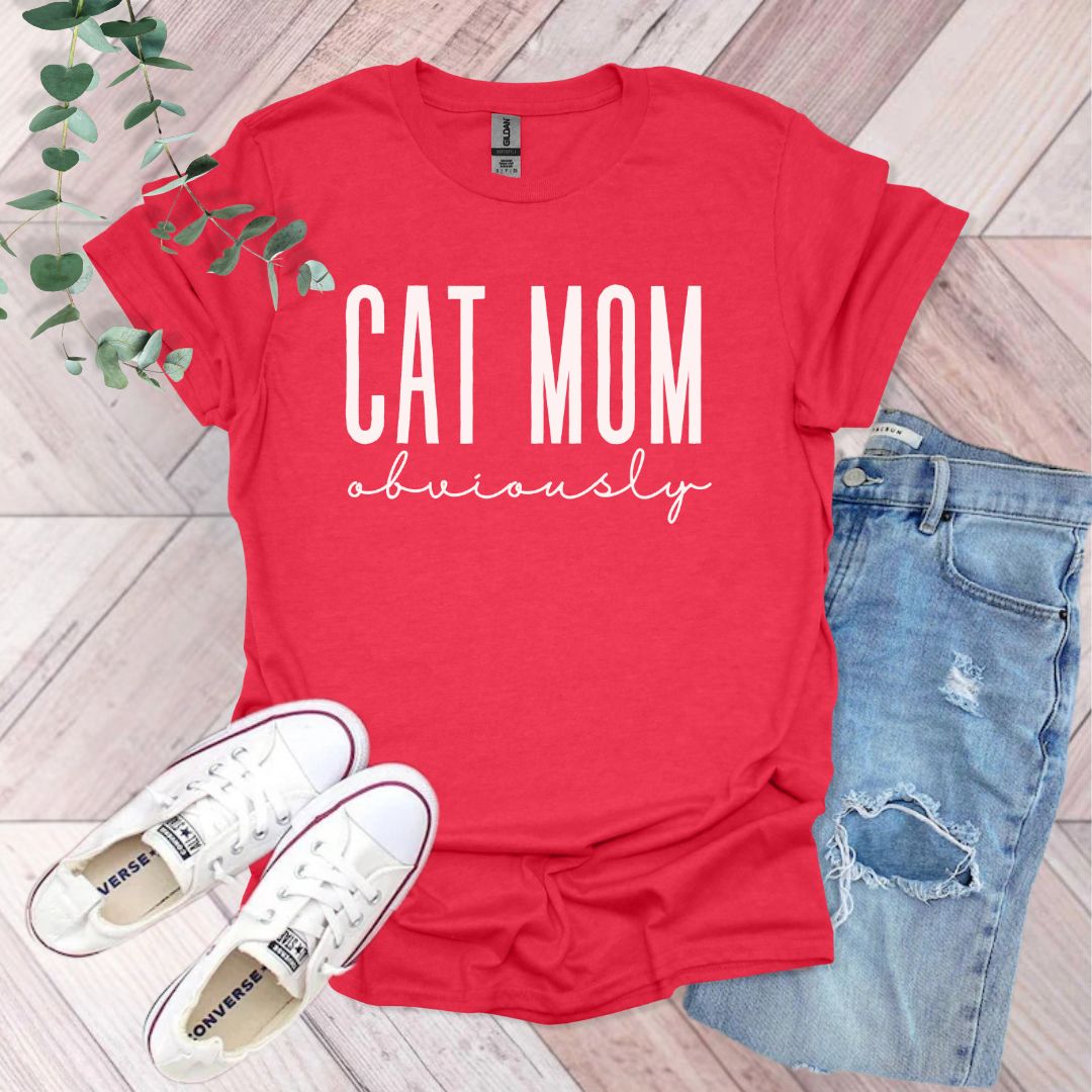 a red shirt that says cat mom university next to a pair of jeans