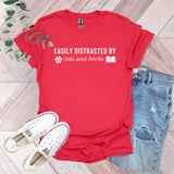 a red t - shirt that says easily distracted by cats and books