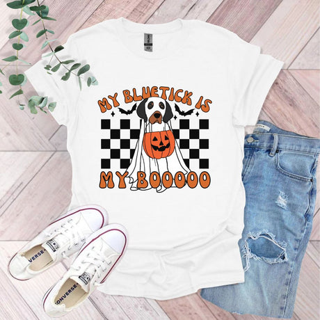 a white t - shirt with a black and white dog wearing a jack o lantern