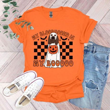 an orange shirt with a black and white dog on it