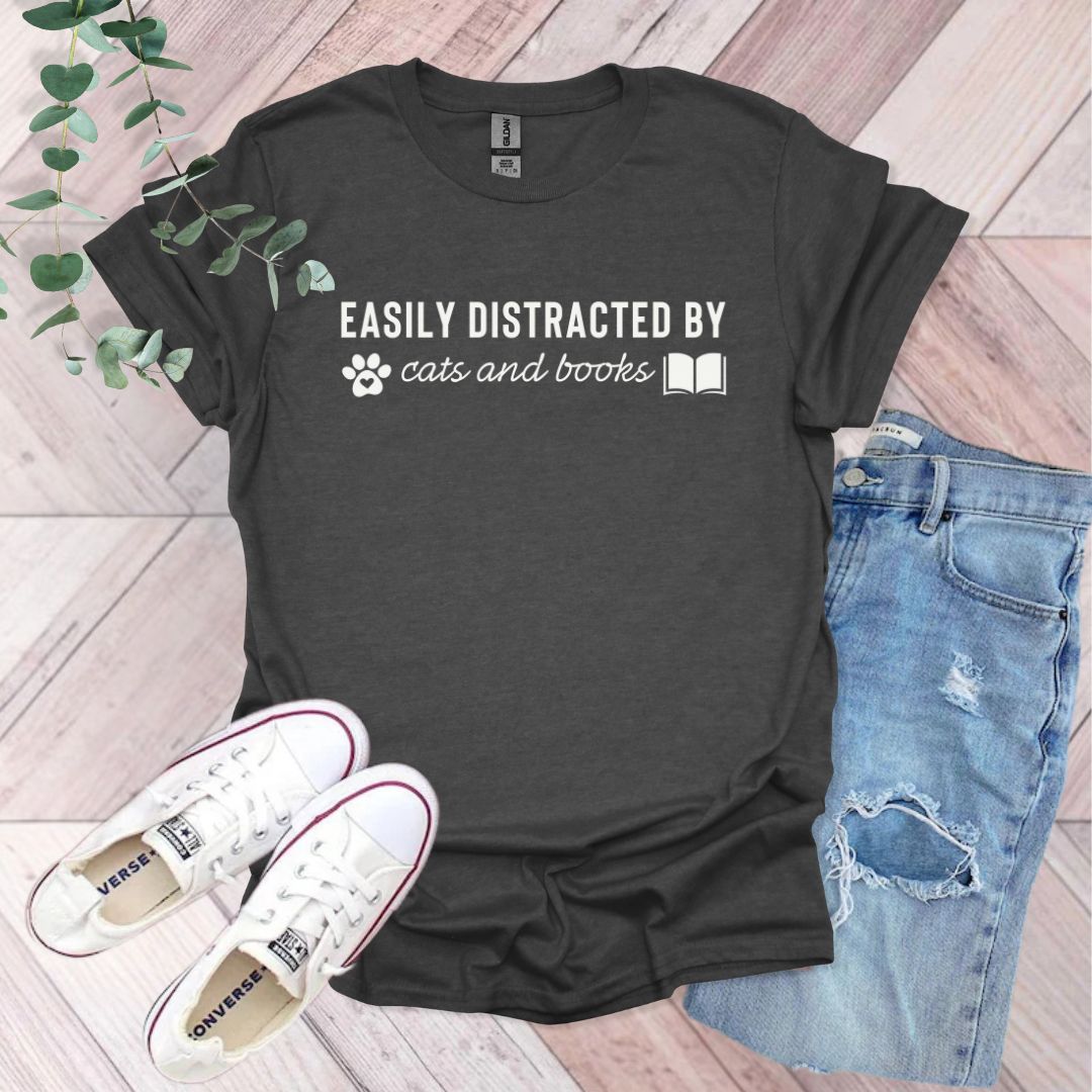 a t - shirt that says easily distracted by cats and books