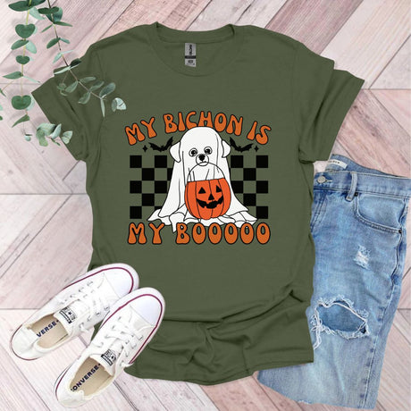 a green shirt with a white dog wearing a jack o lantern pumpkin